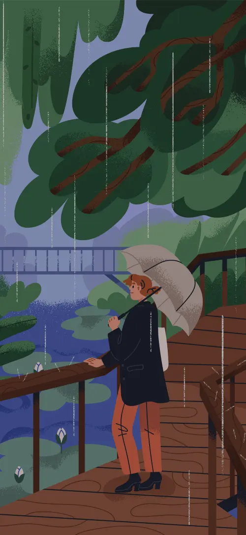 Person holding umbrella in a rainy park